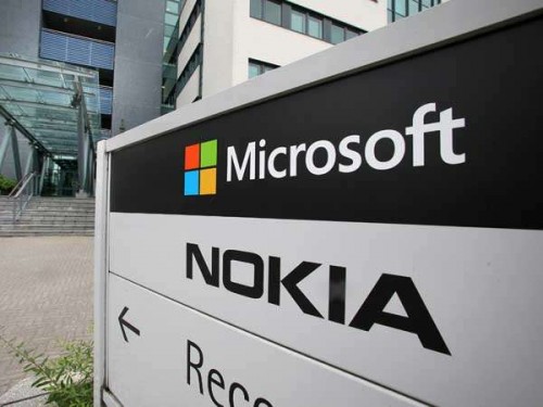 A view of Microsoft and Nokia signs in Peltola, Oulu July 16, 2014. Microsoft Corp said on Thursday it would cut up to 18,000 jobs, or about 14 percent of its workforce, as it halves the size of its recent Nokia acquisition and trims down other operations. Picture taken July 16. REUTERS/Markku Ruottinen/Lehtikuva (FINLAND - Tags: BUSINESS EMPLOYMENT)  ATTENTION EDITORS - THIS PICTURE WAS PROVIDED BY A THIRD PARTY. FOR EDITORIAL USE ONLY. NOT FOR SALE FOR MARKETING OR ADVERTISING CAMPAIGNS. THIS PICTURE IS DISTRIBUTED EXACTLY AS RECEIVED BY REUTERS, AS A SERVICE TO CLIENTS. NO THIRD PARTY SALES. NOT FOR USE BY REUTERS THIRD PARTY DISTRIBUTORS. FINLAND OUT. NO COMMERCIAL OR EDITORIAL SALES IN FINLAND - RTR3Z11D